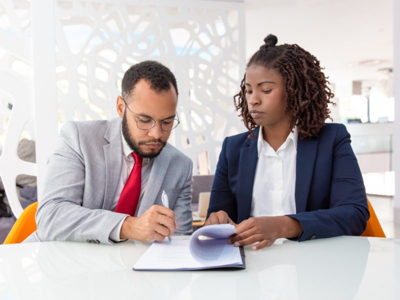 businessman-businesswoman-signing-contract