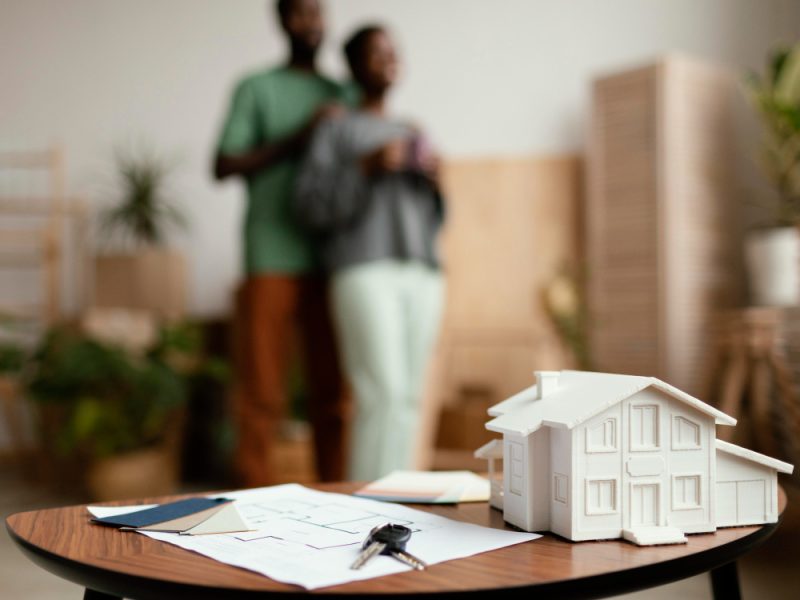 new-home-keys-plan-table-with-defocused-couple